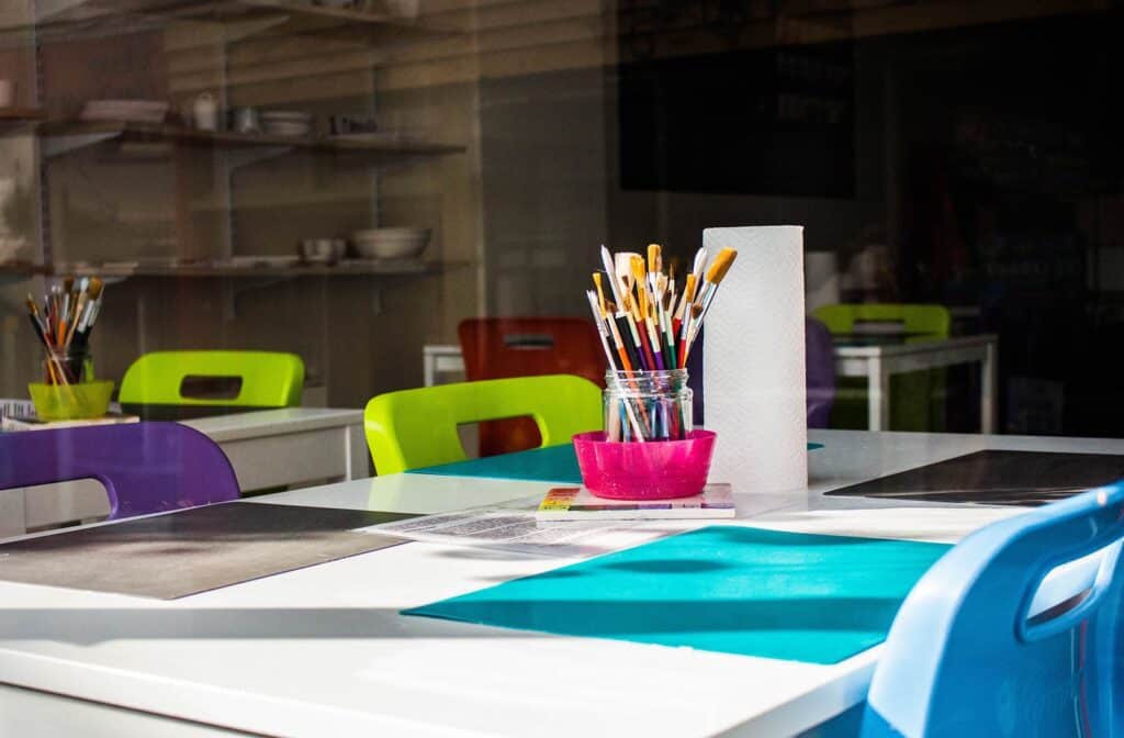 Paintbrushes on a table in a school